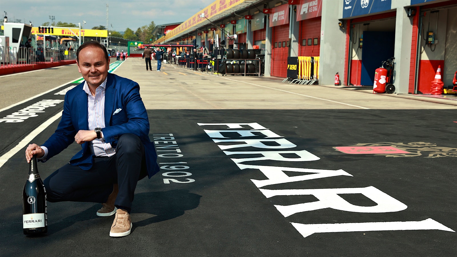 Ferrari Trento CEO Matteo Lunelli poses with a 3-liter bottle of Ferrari sparkling wine at Imola racing circuit in Italy's Emilia-Romagna region.
